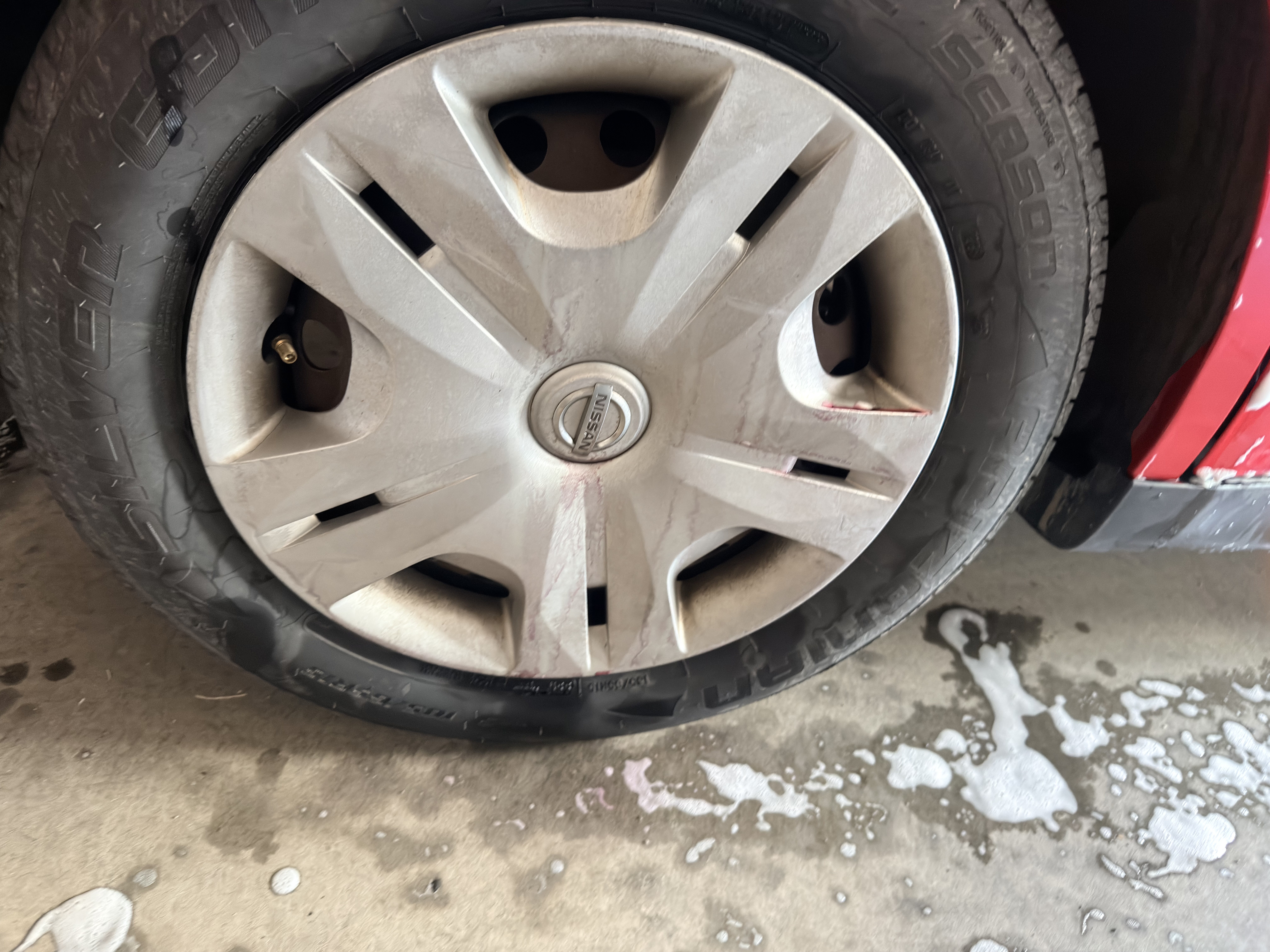 Nissan Versa wheel during cleaning - dirty brake dust and grime
