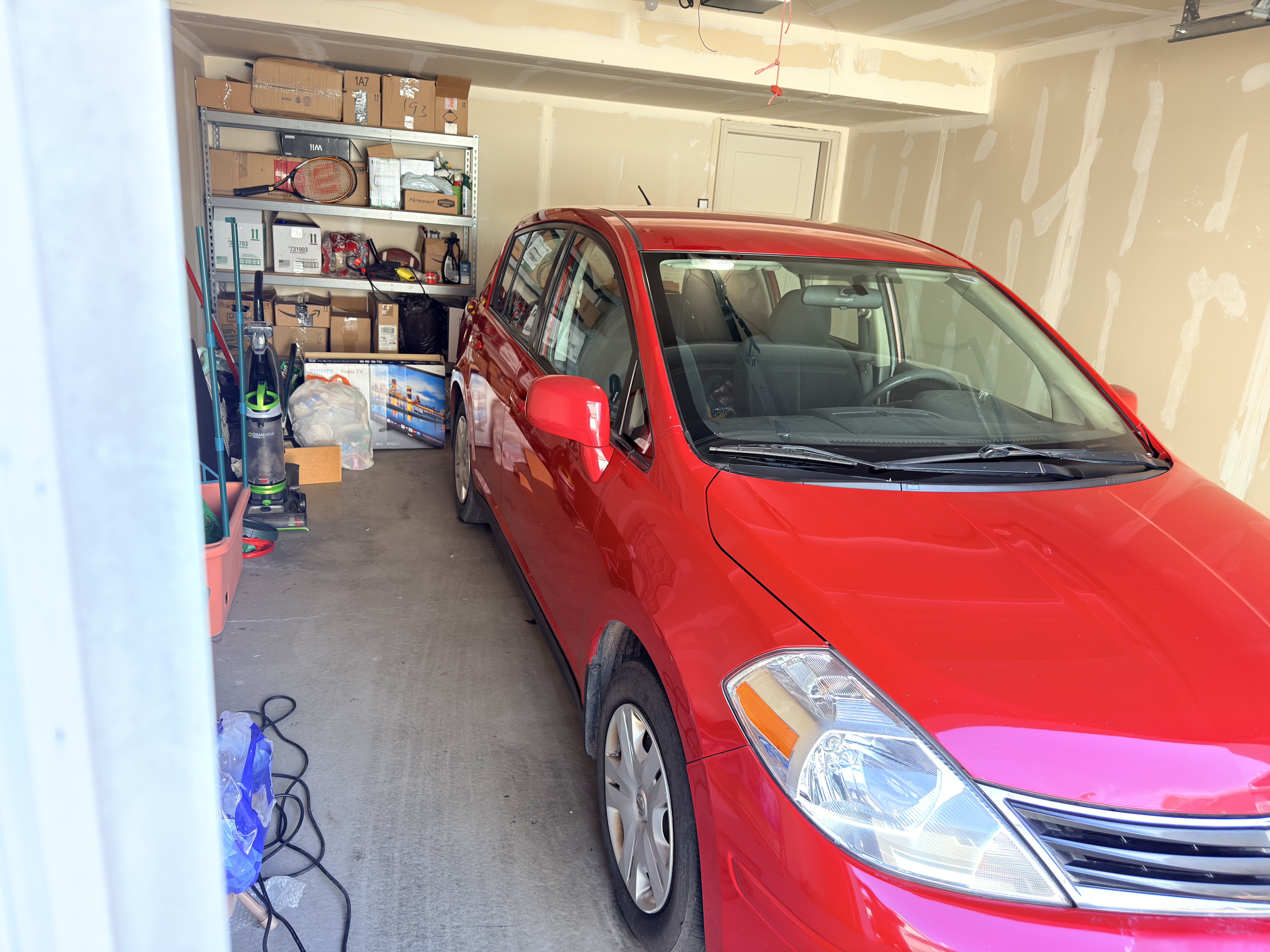 Red Nissan Versa after basic wash - clean side profile